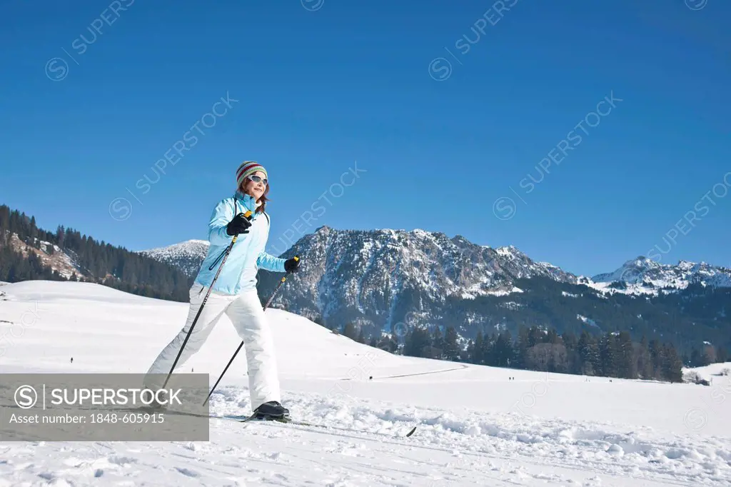 Woman cross-country skiing in the mountains