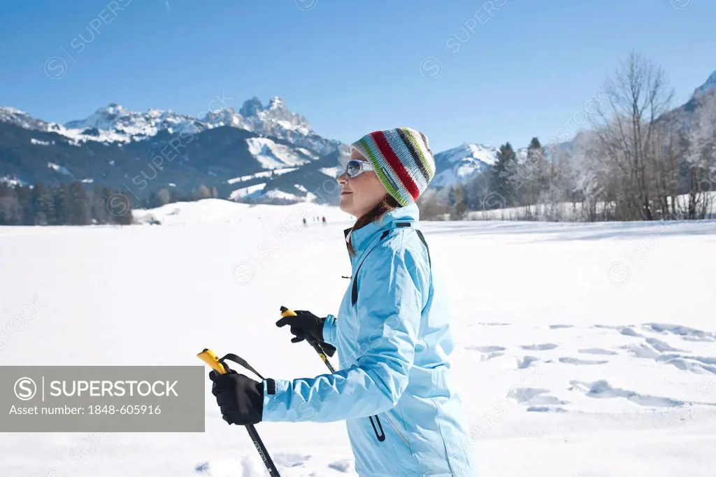 Woman cross-country skiing in the mountains