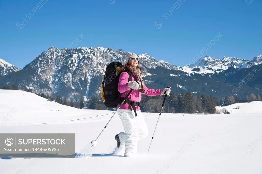 Woman hiking in the snow in the mountains
