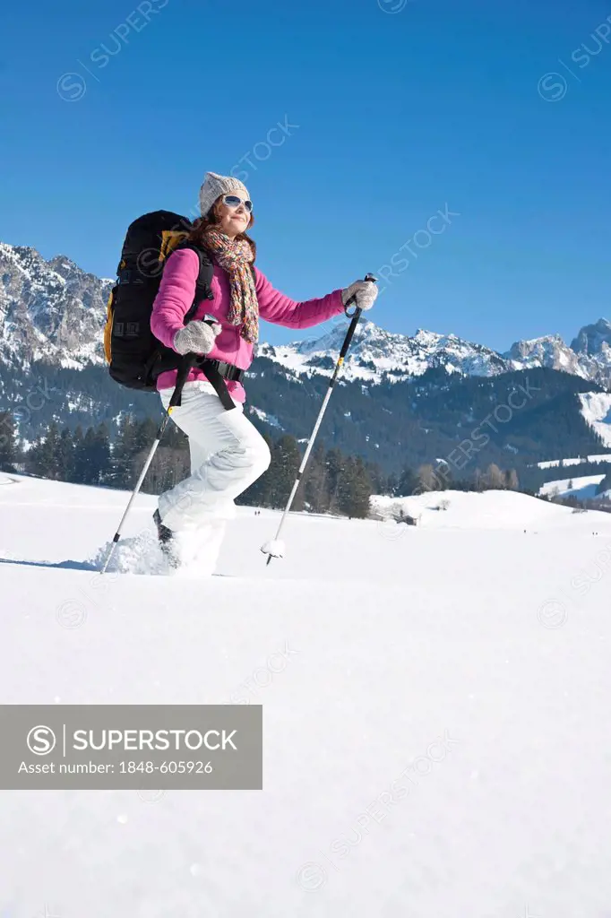 Woman hiking in the snow in the mountains
