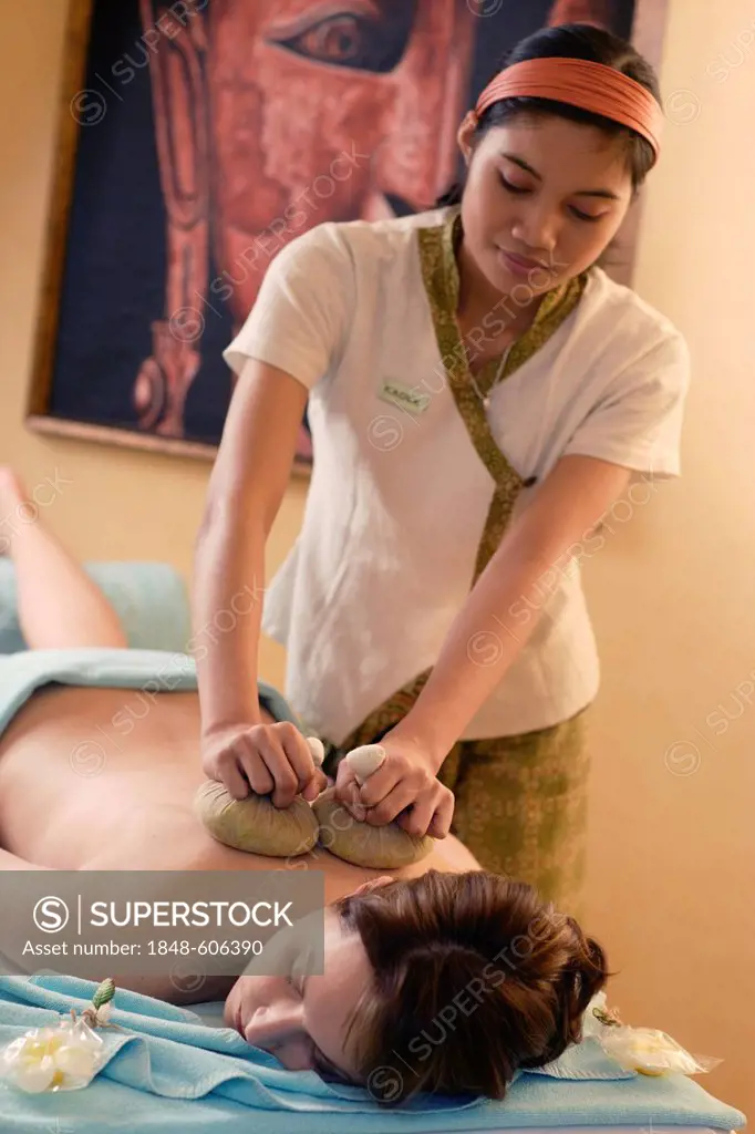 Woman, 35, having a hot herbal compress massage, Ayurvedic treatment