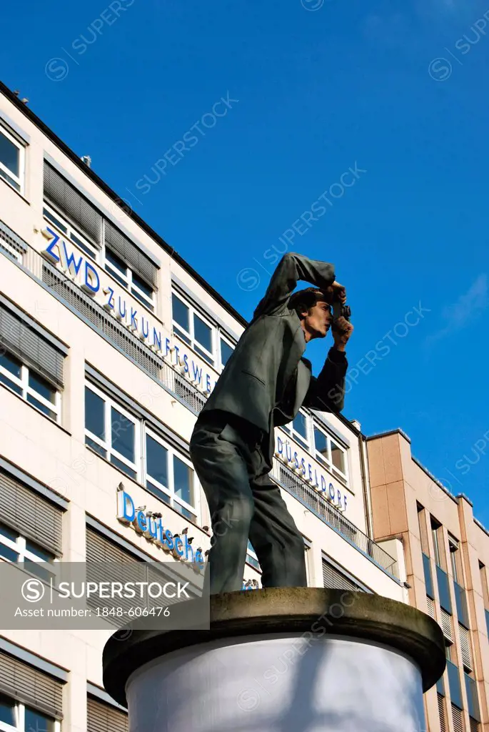 Man taking a photograph, sculpture on an advertising column, Duesseldorf, North Rhine-Westphalia, Germany, Europe