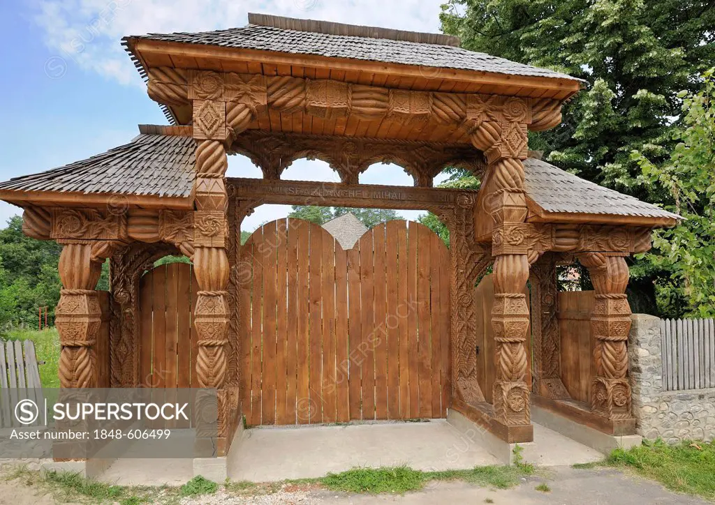 Carved entrance gate next to a small church, Horezu, Oltenia region, Lesser Wallachia, Romania, Europe