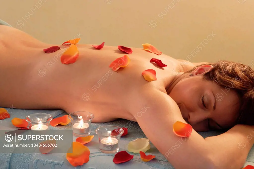 Woman, 35, wellness, relaxing with petals and tea lights