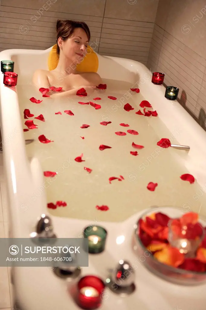 Woman, 35, relaxing in a bathtub with rose petals, Thalasso therapy in a spa resort