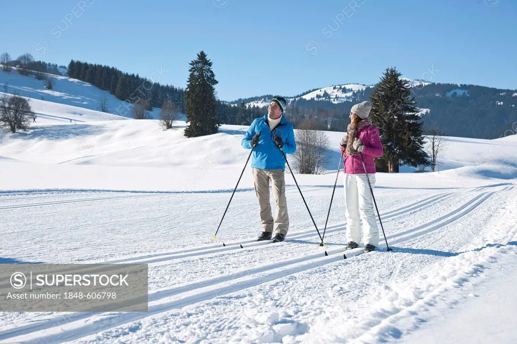 Couple cross-country skiing in the mountains