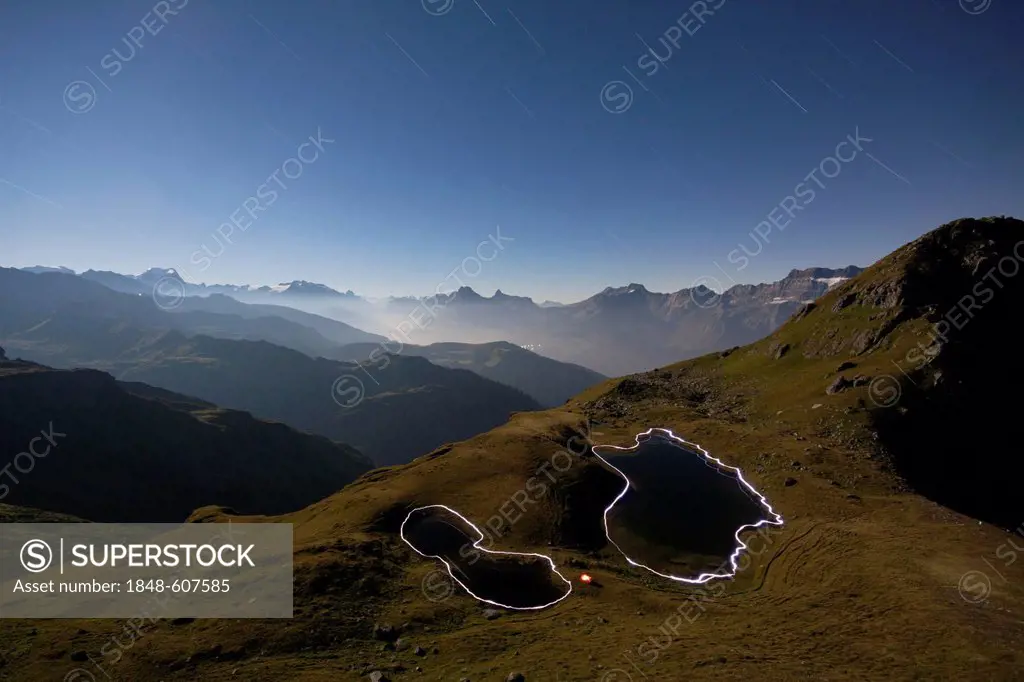 Night view, mountain view at full moon, the contours of the Berglimatt Lakes illuminated by hikers with flashlights, Canton of Glarus, Switzerland, Eu...