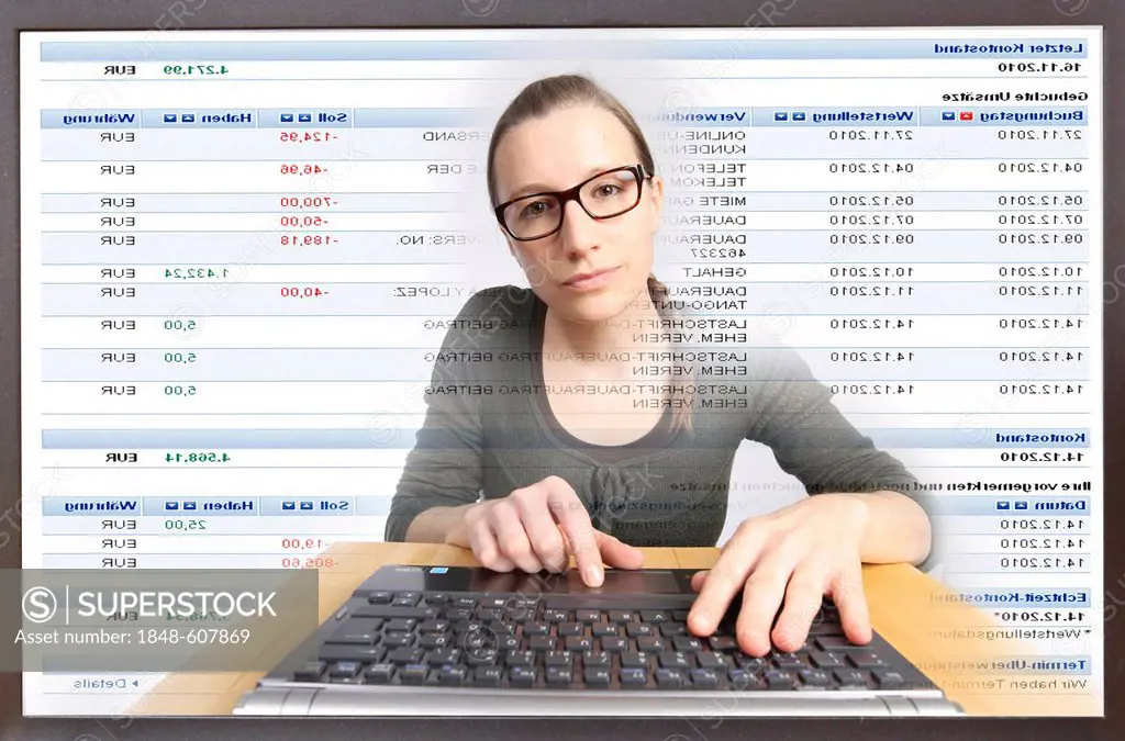 Young woman sitting at a computer surfing the Internet, viewing an Internet banking page, Deutsche Bank, viewing her account statements online, view f...