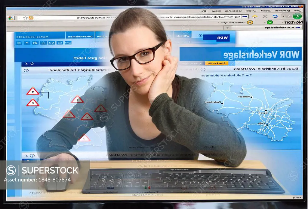 Young woman sitting at a computer surfing the Internet, viewing a page with traffic signs and traffic reports, traffic forecasts, WDR online, view fro...