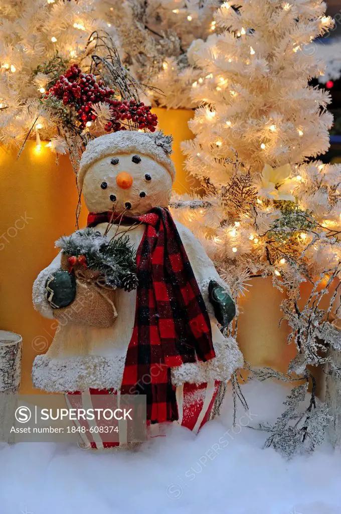 Christmas decorations, snowman in front of a Christmas tree
