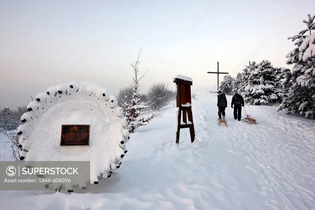 Snow-covered station of the cross on the mining waste heap of pit Haniel near the pit frame, Bottrop, North Rhine-Westphalia, Germany, Europe
