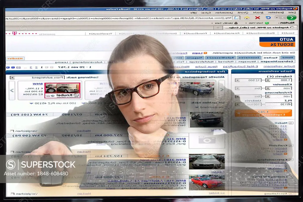 Young woman sitting at a computer surfing the Internet, viewing a page for buying and selling vehicles, autoscout24.de, view from within the computer,...