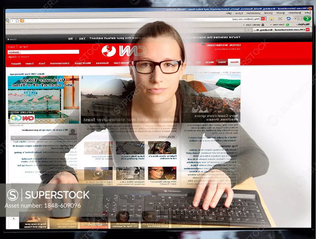 Young woman sitting at a computer surfing the Internet, viewing a page of the American news channel CNN, view from within the computer, symbolic image