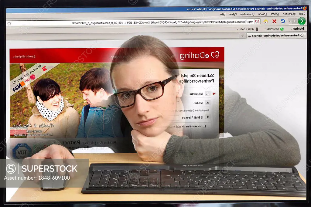 Young woman sitting at a computer surfing the Internet, viewing a page with contact ads, a flirt portal, view from within the computer, symbolic image