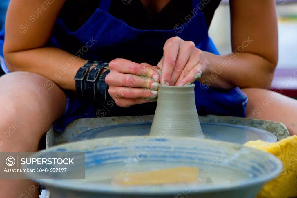 Person making pottery