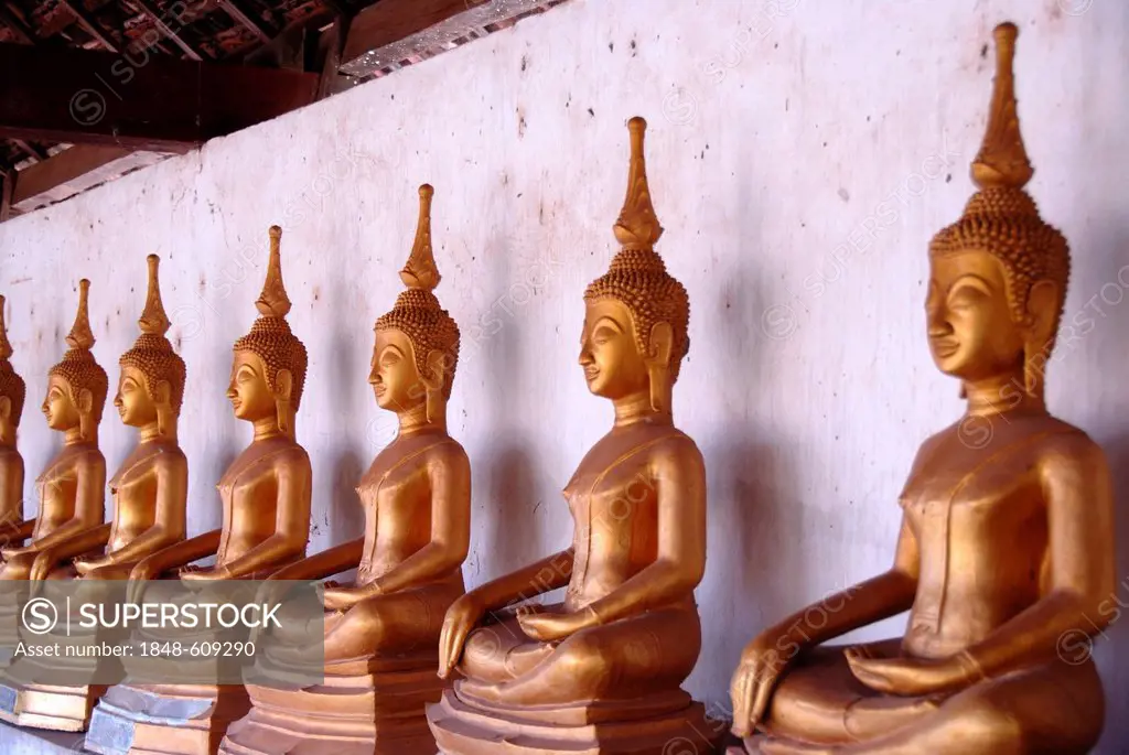 Theravada Buddhism, meditation, row of bronze Buddha statues, temple, That Ing Hang Stupa, in Savannakhet, Laos, Southeast Asia, Asia