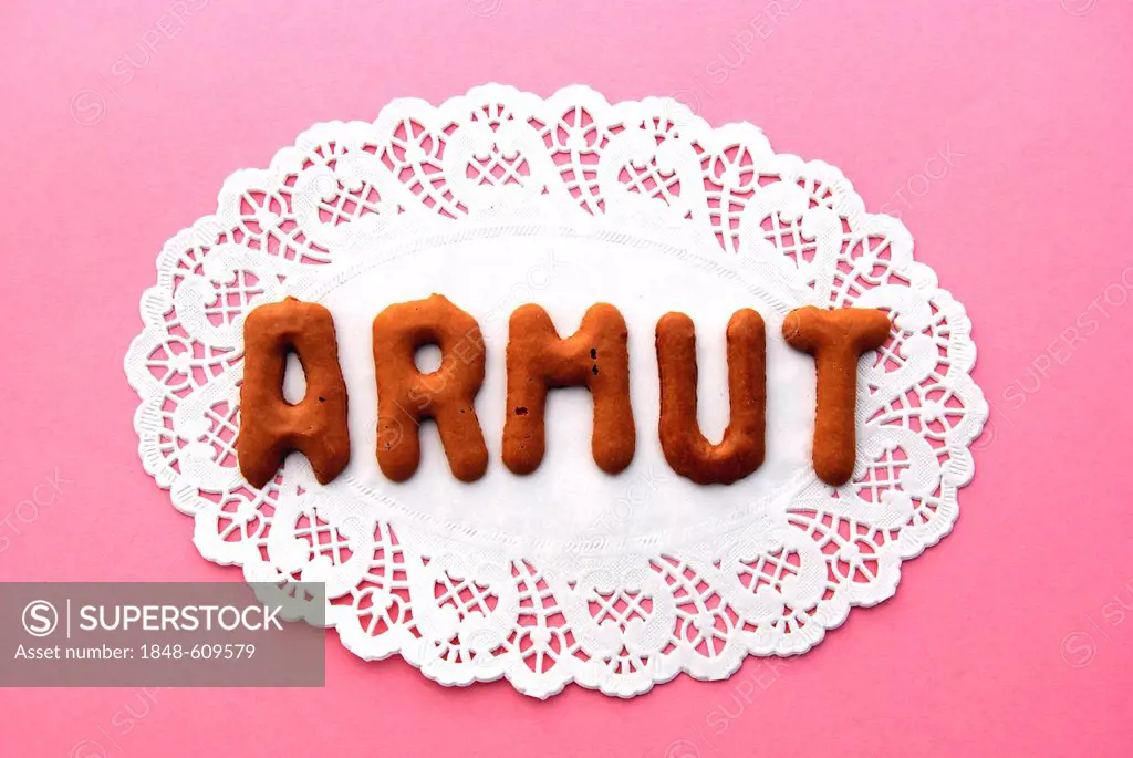 Lettering Armut, German for poverty, alphabet biscuits on a cake lace coaster