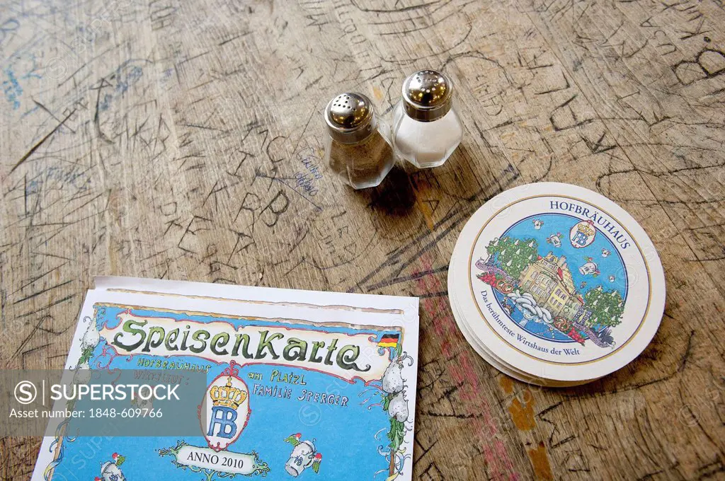 Salt and pepper shakers, beer coasters and a menu on a table in Hofbraeuhaus, a beer hall, beer culture, Munich, Bavaria, Germany, Europe