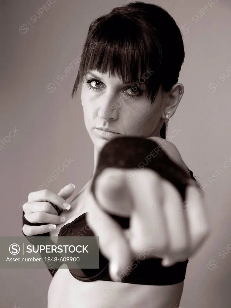 Woman dressed in a Goth style pointing her finger