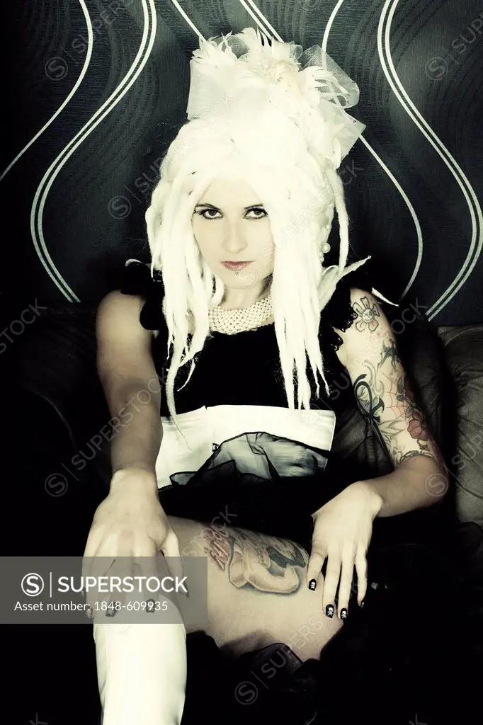 Woman sitting on a sofa, Gothic style, Retro style, tattoo