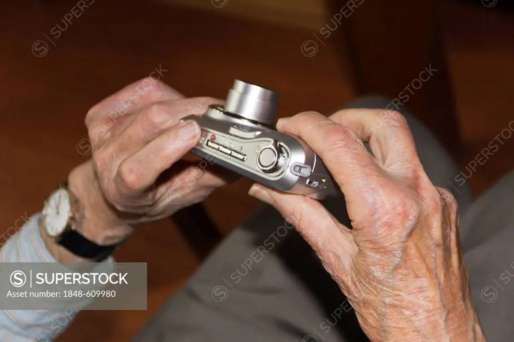 Old person's hands holding a digital camera, nursing home, retirement home, Berlin, Germany, Europ