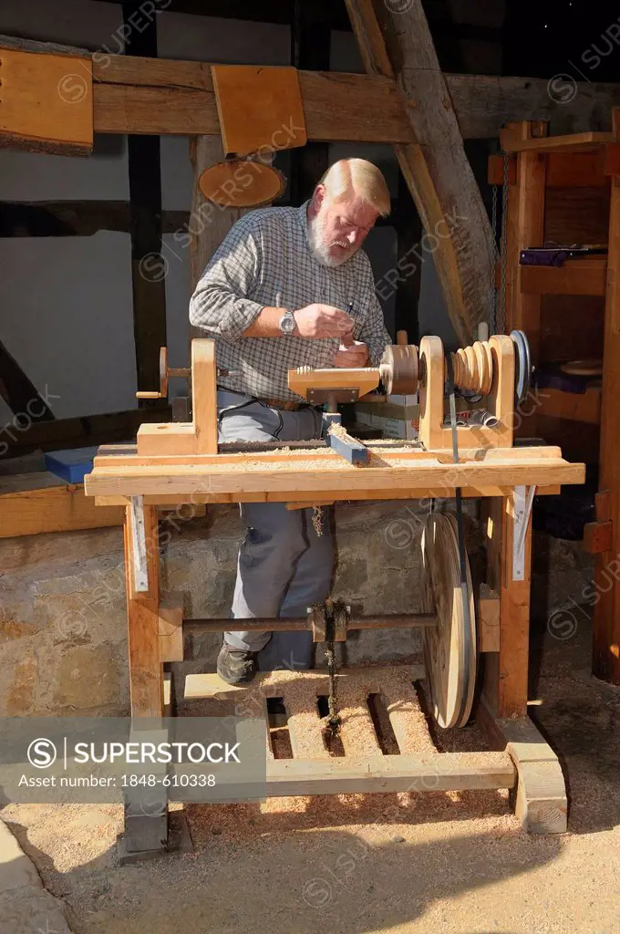 Turner working on a foot powered lathe, Hessenpark outdoor museum near Neu-Anspach, Hochtaunuskreis district, Hesse, Germany, Europe