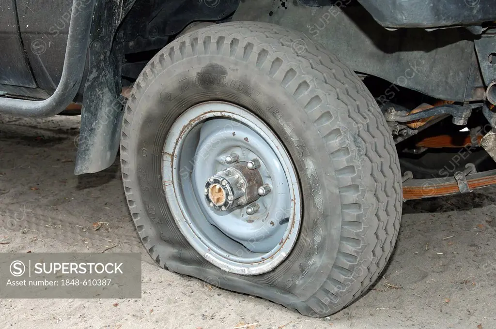 Flat Dunlop tyre on a jeep, Moremi Nature Reserve, Botswana, Africa