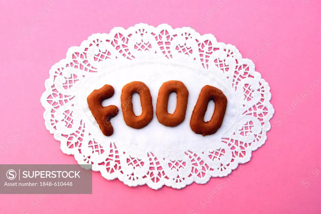 Food, lettering, alphabet biscuits on a cake lace coaster