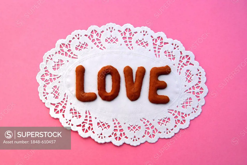 Love, lettering, alphabet biscuits on a cake lace coaster