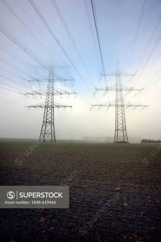Electricity pylons and power lines in the autumn mist, Gelsenkirchen, North Rhine-Westphalia, Germany, Europe