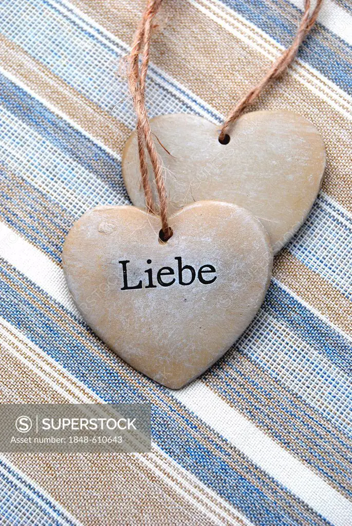 Two hearts of stone, lettering Liebe, German for love, symbolic image for solidarity