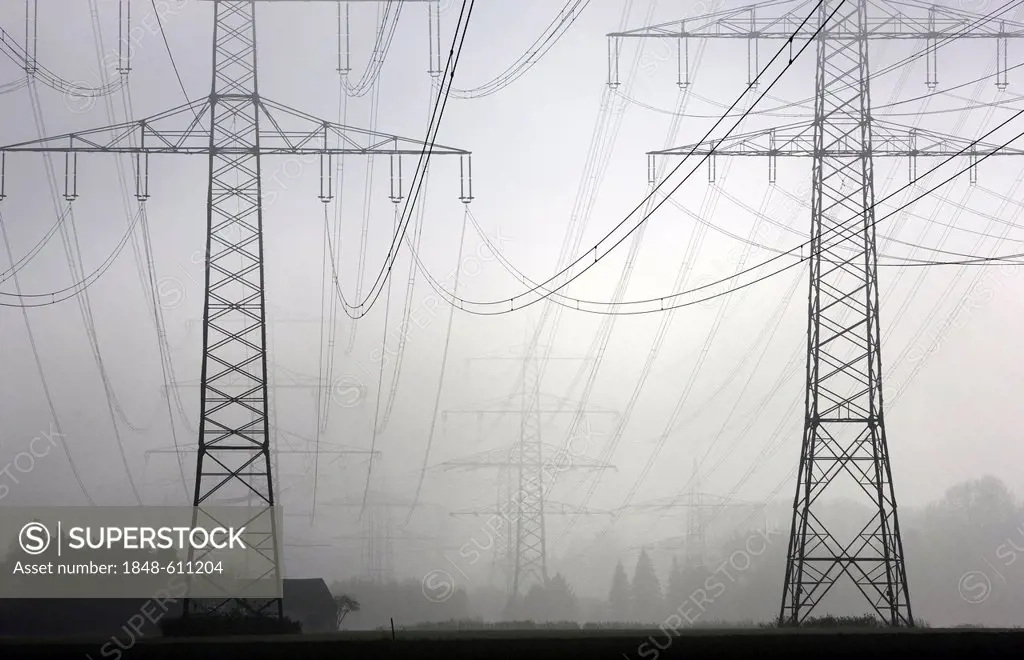 Electricity pylons and power lines in the autumn mist, Gelsenkirchen, North Rhine-Westphalia, Germany, Europe