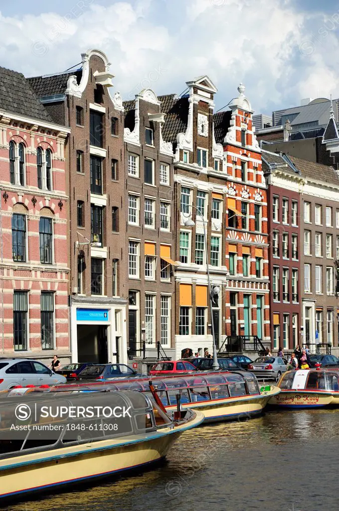 Facades of residential houses on a canal, excursion boats on the Oude Turfmarkt Canal, historic city centre, Amsterdam, North Holland, Noord-Holland, ...