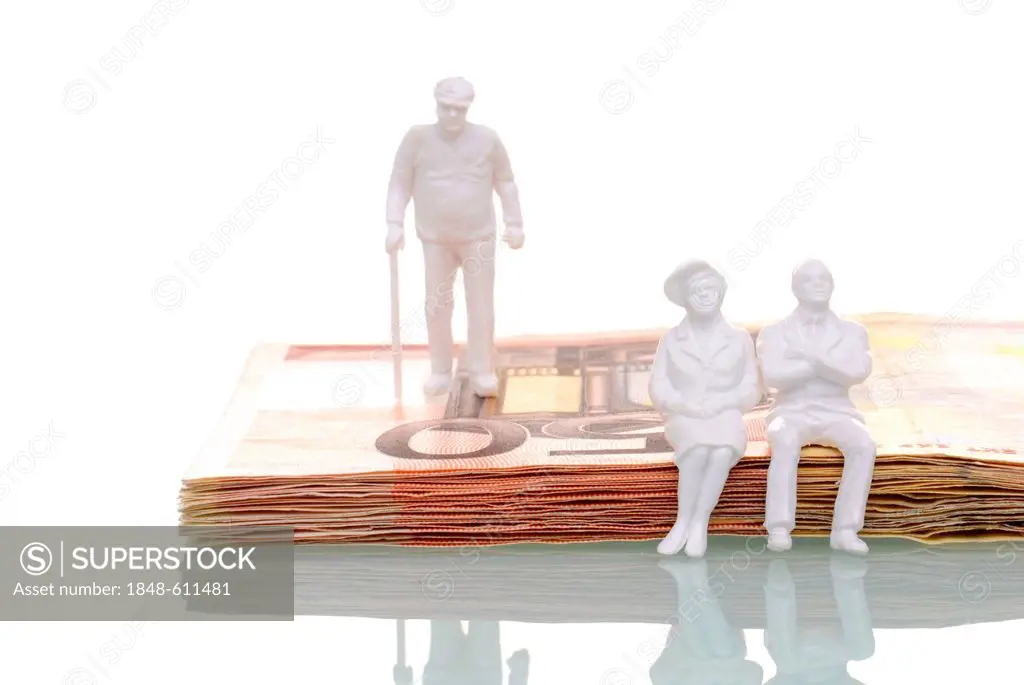 Pensioners, figures sitting on a stack of fifty euro banknotes, symbolic image for retirees putting their money aside