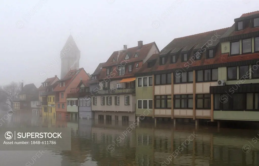 Floodwaters and fog, buildings on the bank of the Tauber river, seen from the Tauber river bridge on Bahnhofstrasse street from direction of Main estu...