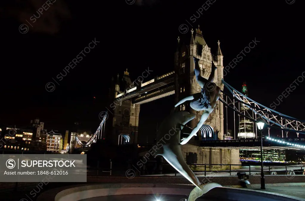 Illuminated Tower Bridge with the sculpture Girl with a Dolphin by David Wynne, at night, River Thames, London, England, United Kingdom, Europe