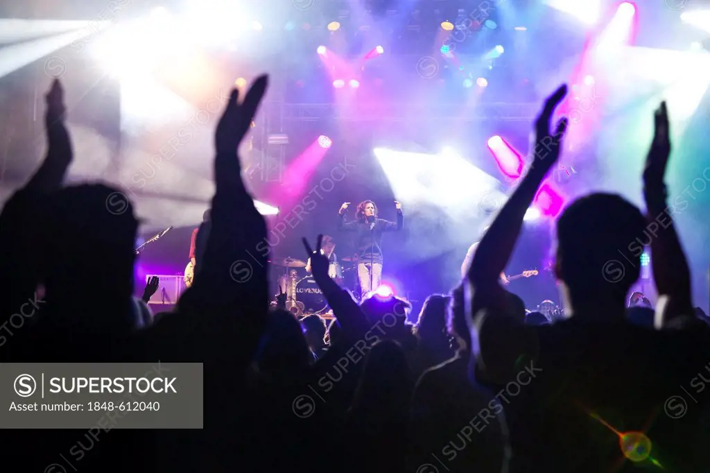 Visitors of the open-air festival cheering for the Swiss pop band Lovebugs at the Soundcheck Open Air in Sempach-Neuenkirch, Lucerne, Switzerland, Eur...