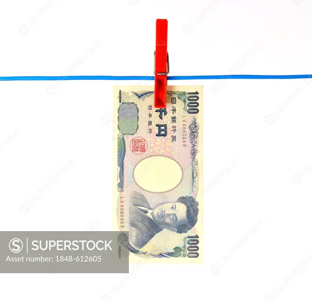 Japanese Yen bank note on a clothesline, symbolic image for money laundering, dirty money