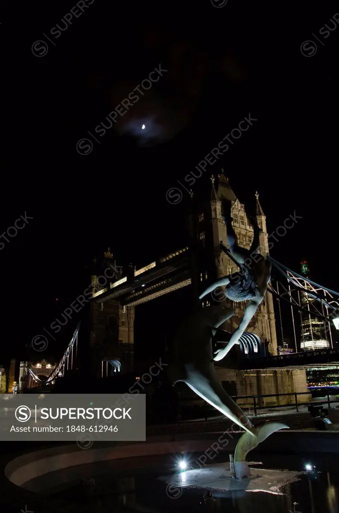 Illuminated Tower Bridge with the sculpture Girl with a Dolphin by David Wynne, at night, River Thames, London, England, United Kingdom, Europe
