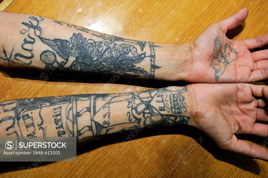 Tattoos on the arms of a former Mara, a former hired killer and member of a gang of youths, on his right arm grave stones of murdered people and the n...
