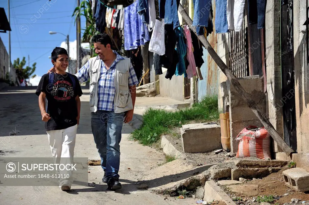 Teenager, 16 years old, with a social worker, Lomas de Santa Faz slum, Guatemala City, Guatemala, Central America