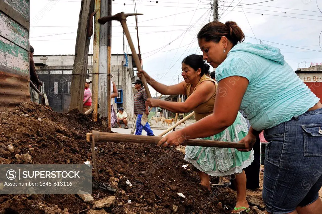Women working together to improve the sewer system of their neighborhood, Lomas de Santa Faz slum, Guatemala City, Guatemala, Central America
