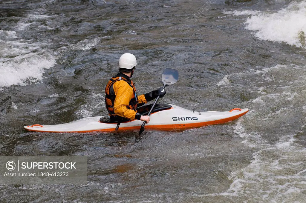 Whitewater kayaker maneuvering through the rapids