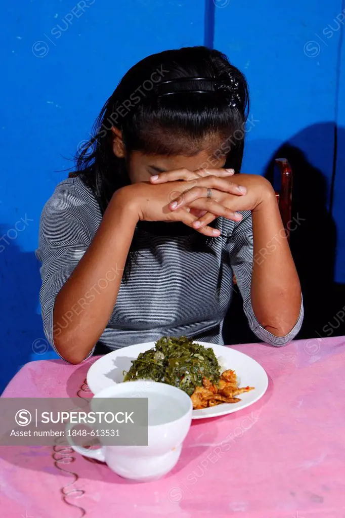 Girl during a meal, Gelora Kasih orphanage, Kabanjahe, Batak region, Sumatra, Indonesia, Southeast Asia, Asia