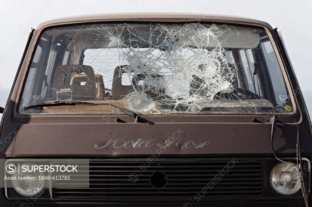 Old minibus with smashed in windscreen, safety glass