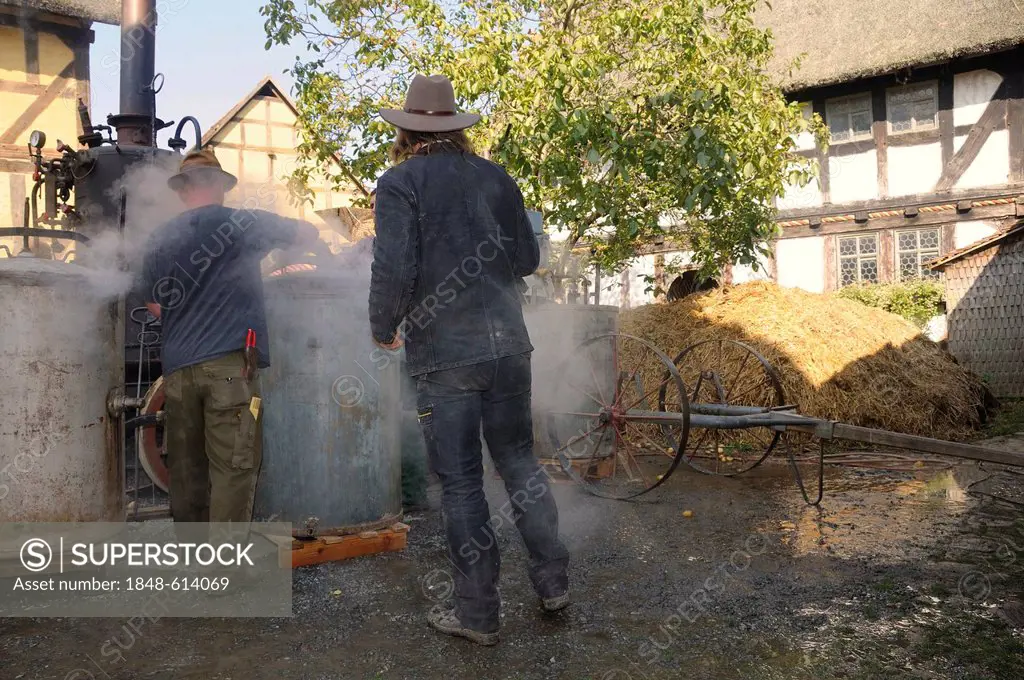 Men steaming potatoes in a potatoe-steamer, Hessenpark outdoor museum near Neu-Anspach, Hochtaunuskreis district, Hesse, Germany, Europe