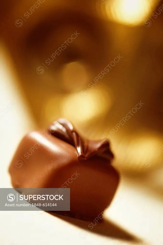 Praline on gold-colored background
