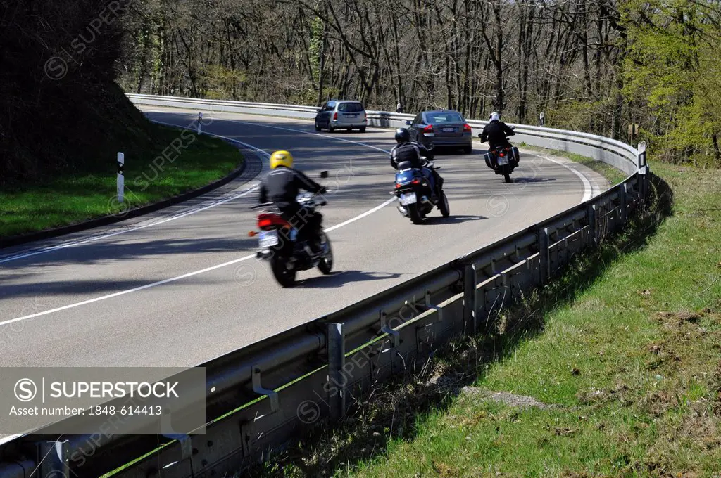 Motorcyclists in a curve on a country road with guard rail for protection, Eifel, Germany, Europe