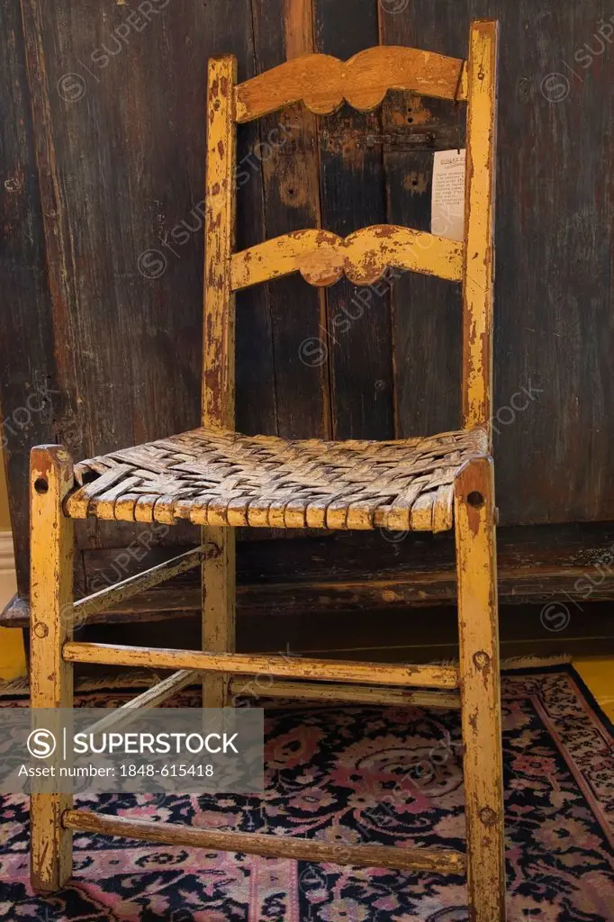 Antique wooden chair and armoire inside an old residential home and antique store, Lanaudiere, Quebec, Canada. This image is property released for cal...