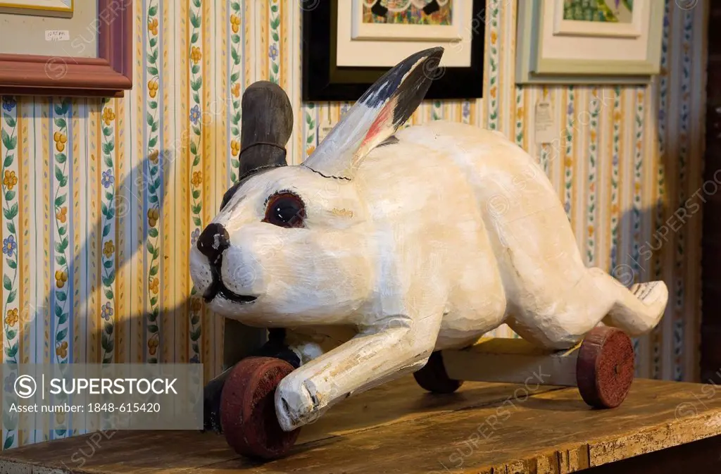 Antique wooden toy hare inside an old residential home and antique store, Lanaudiere, Quebec, Canada. This image is property released for calendar, bo...